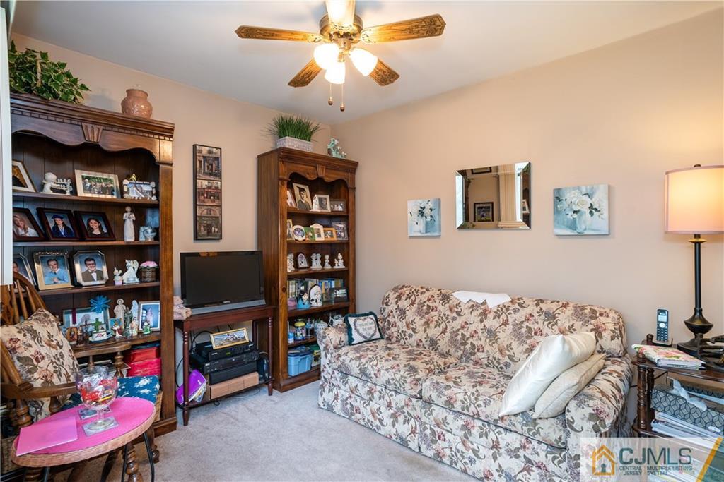 55 Gramercy Road Old Bridge, NJ 08857 - Photo 9 of 22 a bedroom with furniture and a book shelf