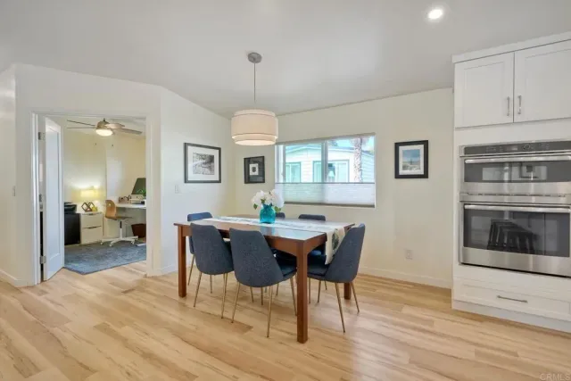a view of a dining room with furniture window and wooden floor