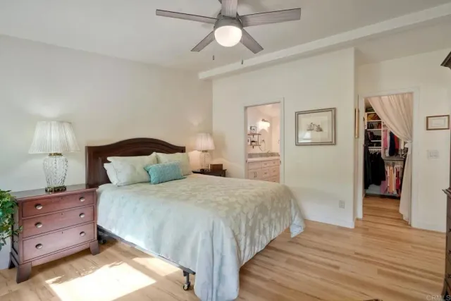 a view of a hallway with furniture and white walls