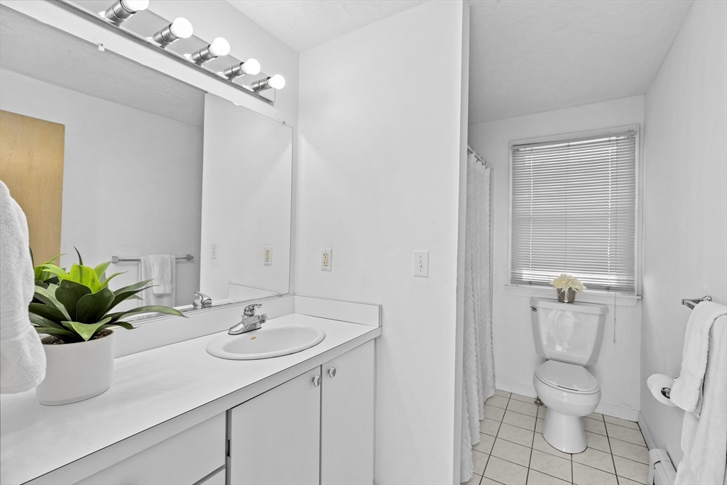 5 Silver Road Scituate, MA 02050 - Photo 12 of 30 a bathroom with a sink a toilet and a mirror