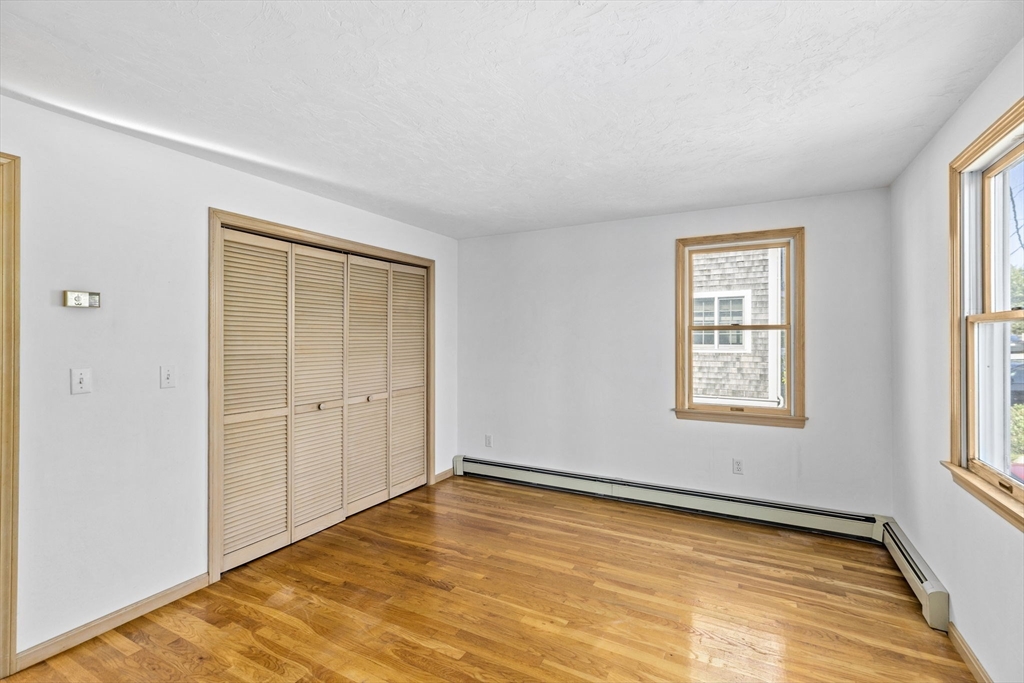 5 Silver Road Scituate, MA 02050 - Photo 13 of 30 a view of an empty room with wooden floor and a window