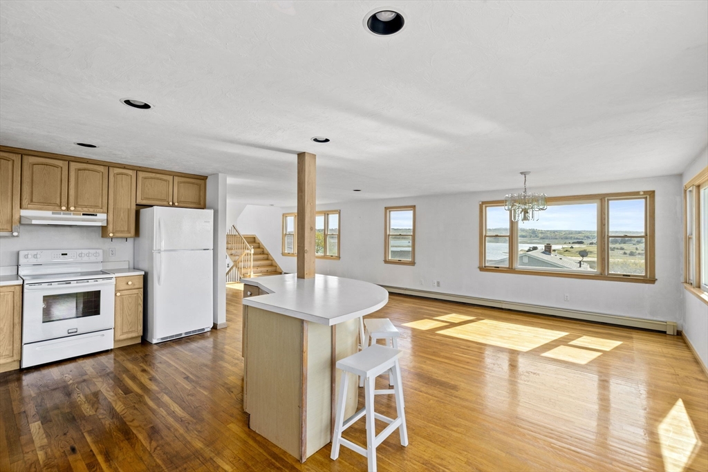 5 Silver Road Scituate, MA 02050 - Photo 5 of 30 a living room with stainless steel appliances granite countertop a coffee maker a sink and a refrigerator