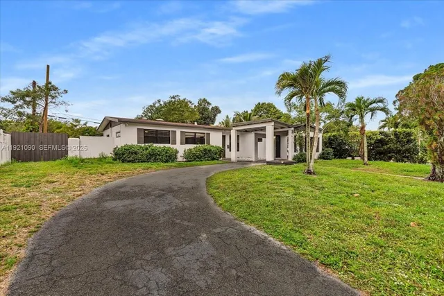 a front view of house with yard and green space