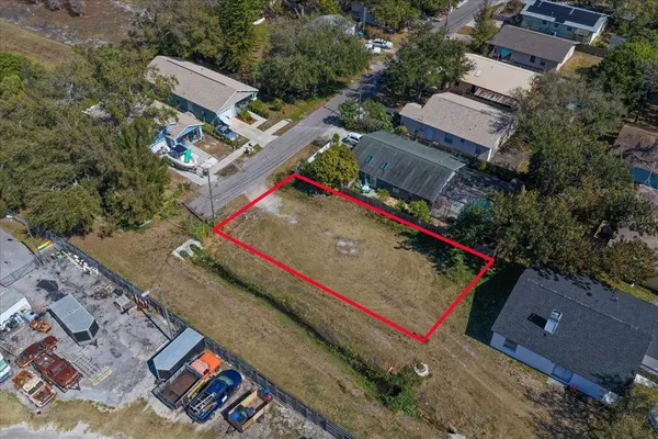 an aerial view of a house with a yard and outdoor seating