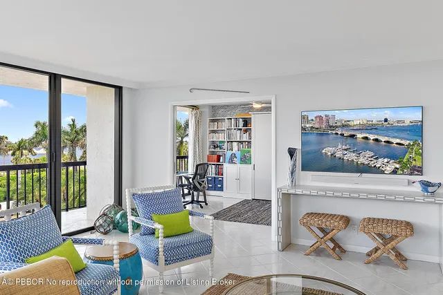 a living room with furniture and a floor to ceiling window