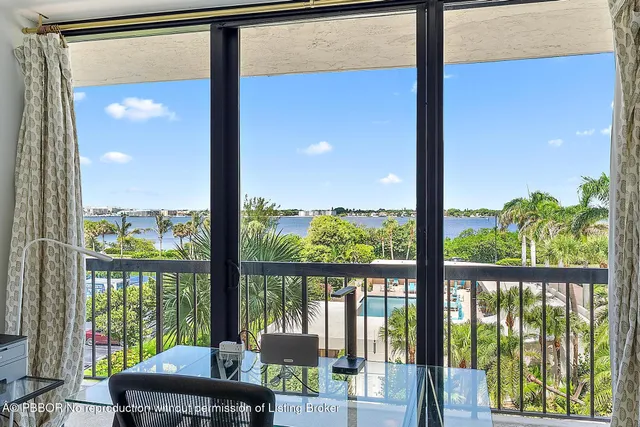 a room view with a balcony and ocean view