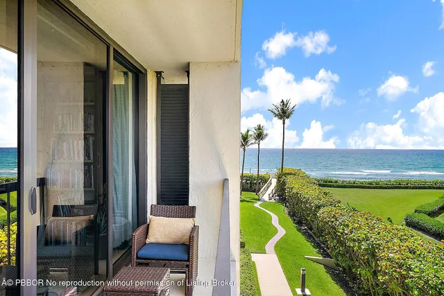 a view of a swimming pool with an outdoor seating