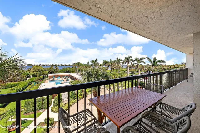 a bedroom with a balcony a bed and a flat screen tv
