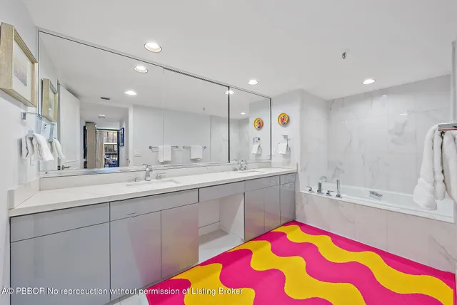 a bathroom with a sink mirror and vanity