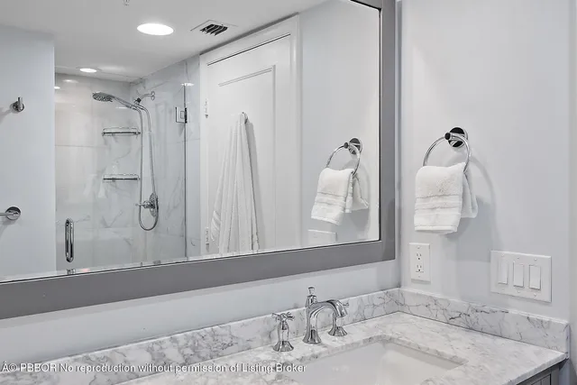 a bathroom with a granite countertop sink a toilet and a mirror