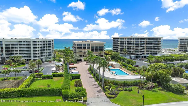 a view of a multi story building with yard and seating area