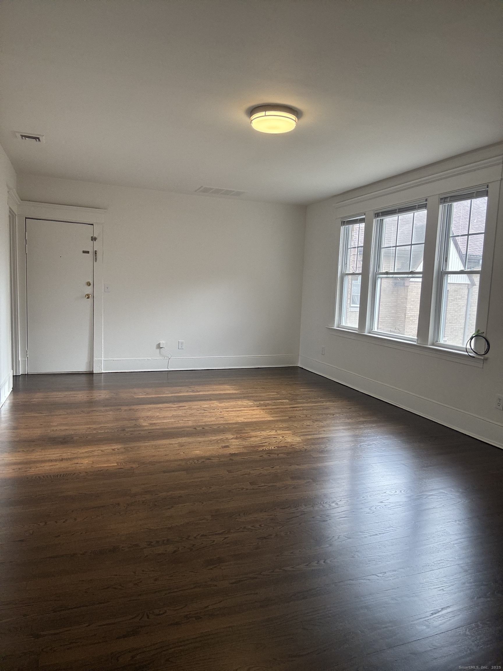 155 Elm Street, Unit 6 West Haven, CT 06516 - Photo 3 of 8 wooden floor in an empty room with a window