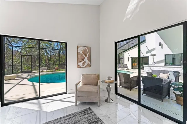 a living room with furniture and a floor to ceiling window