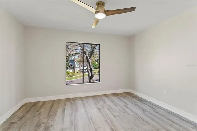 a view of yard from deck with patio