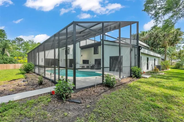 a view of a house with a yard and sitting area