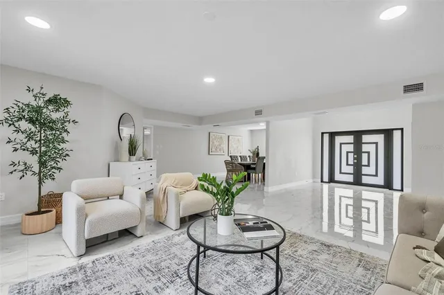 a living room with furniture and a potted plant