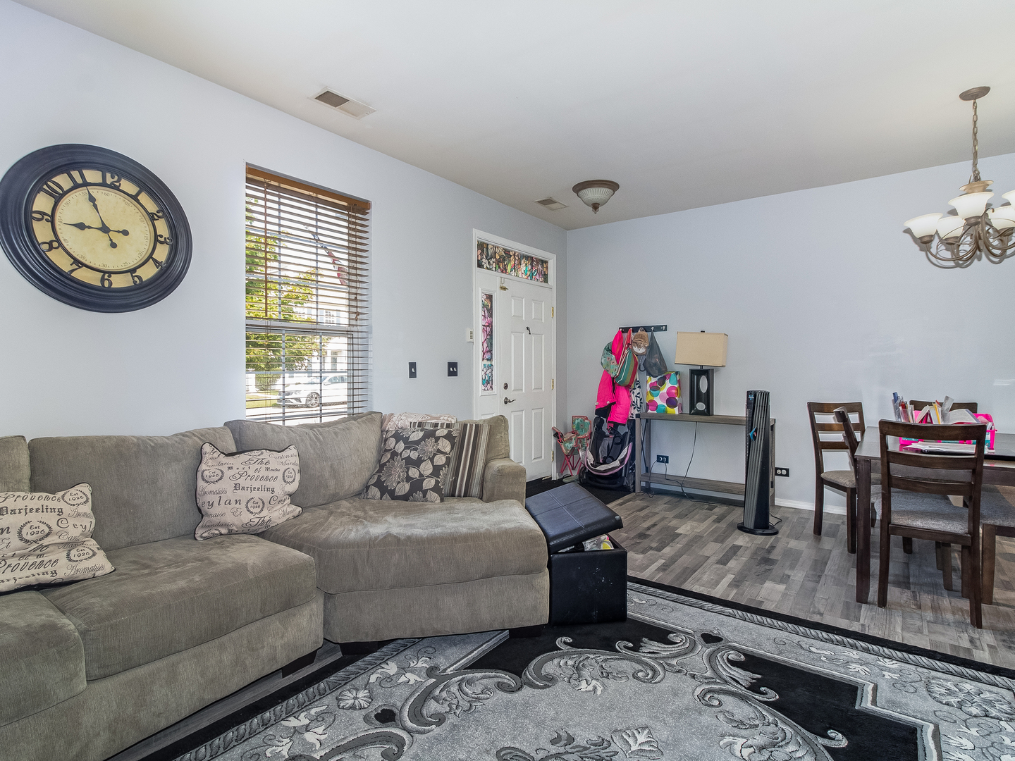 2262 Georgetown Circle Aurora, IL 60503 - Photo 4 of 25 a living room with furniture a clock and a window
