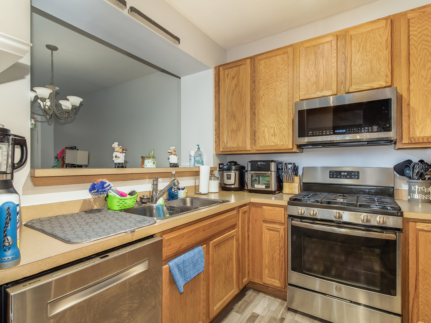 2262 Georgetown Circle Aurora, IL 60503 - Photo 8 of 25 a kitchen with stainless steel appliances granite countertop a stove a sink and a microwave