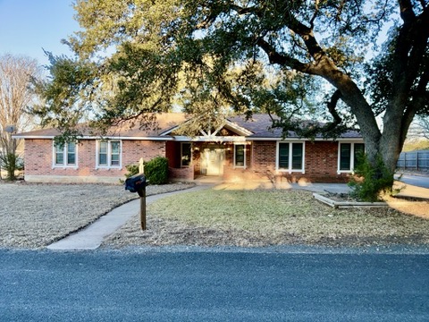 Ranch-style home featuring brick siding