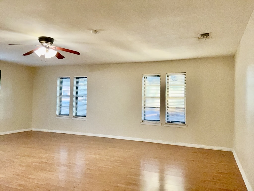 418 Sunset Drive Georgetown, TX 78628 - Photo 11 of 26 Second living room with light wood-type flooring, healthy amount of natural light, a ceiling fan, and a textured ceiling