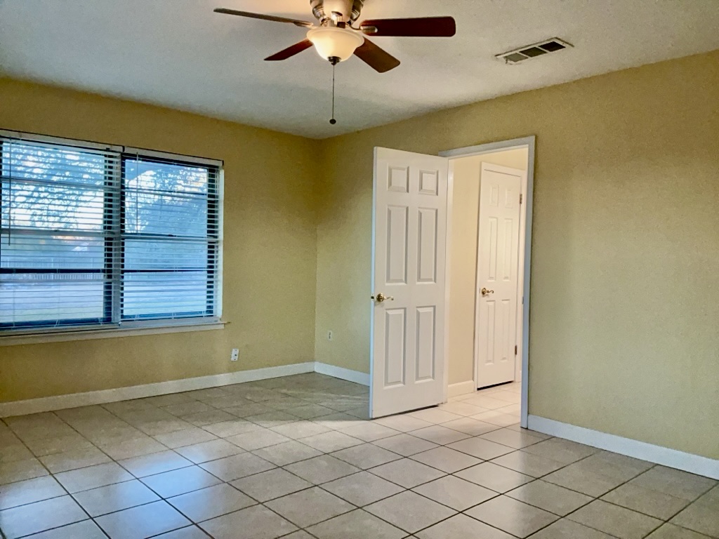 418 Sunset Drive Georgetown, TX 78628 - Photo 15 of 26 Bedroom featuring a ceiling fan, healthy amount of natural light, and light tile patterned floors