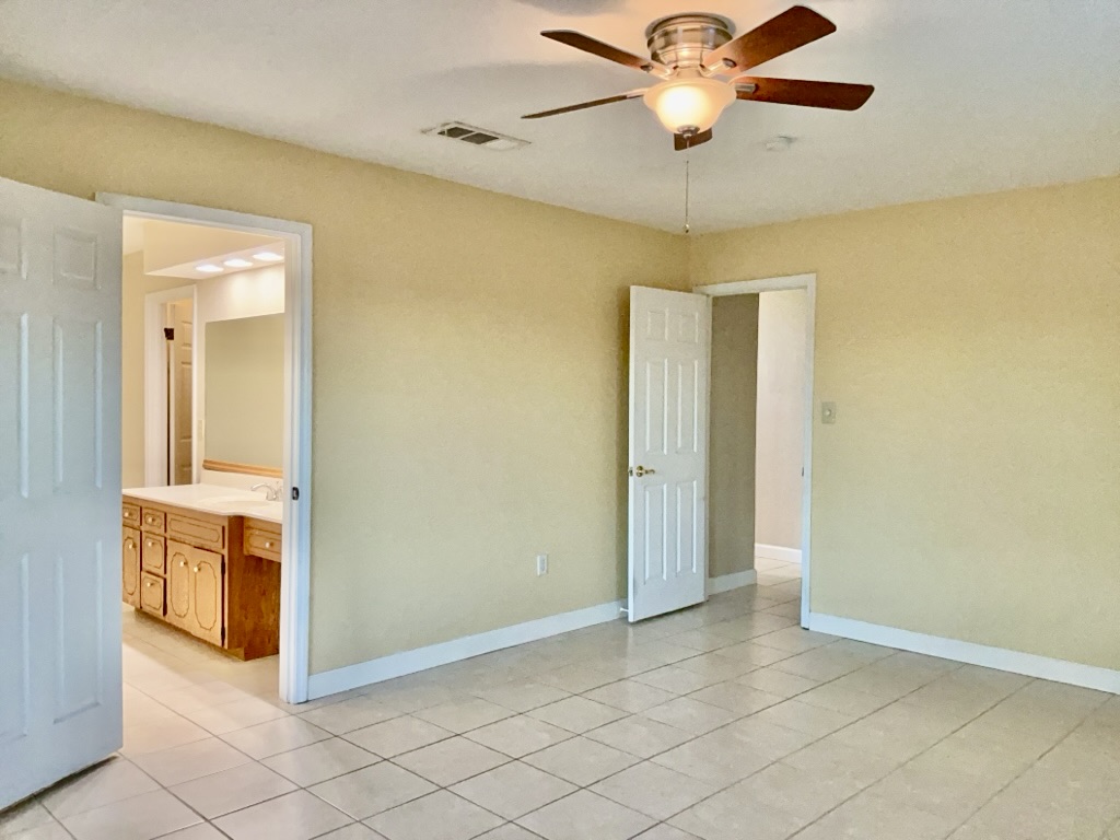 418 Sunset Drive Georgetown, TX 78628 - Photo 16 of 26 Bedroom featuring a ceiling fan, healthy amount of natural light, and light tile patterned floors