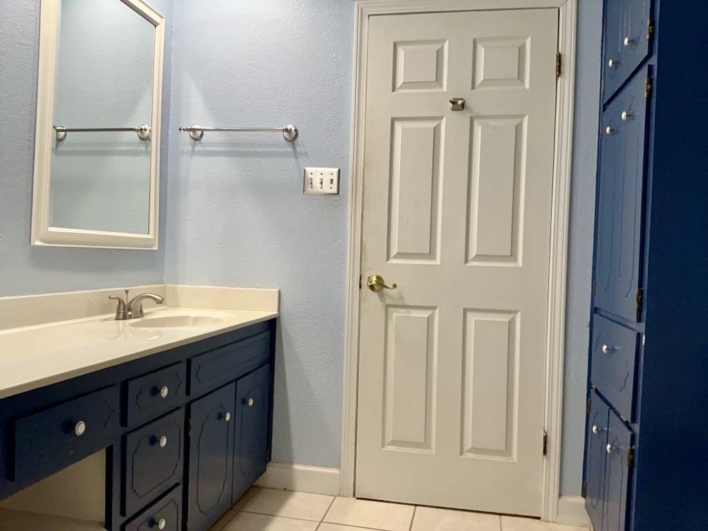 418 Sunset Drive Georgetown, TX 78628 - Photo 21 of 26 Bathroom with a textured wall, vanity, and light tile patterned flooring