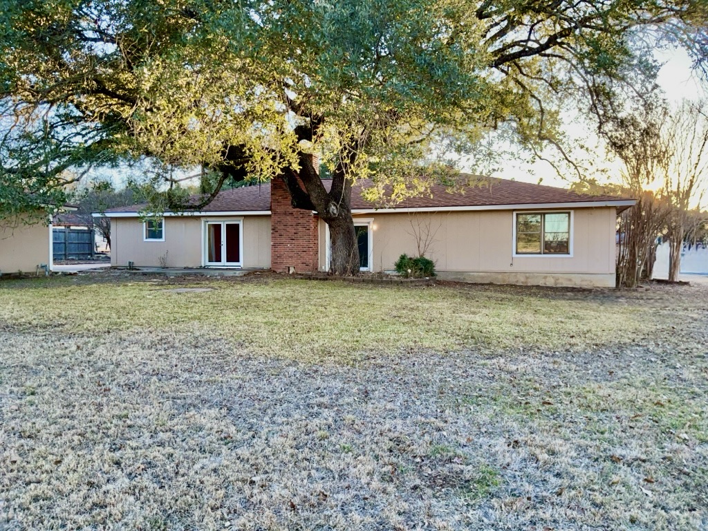 418 Sunset Drive Georgetown, TX 78628 - Photo 26 of 26 View of front of home featuring a front lawn, a shingled roof, and french doors
