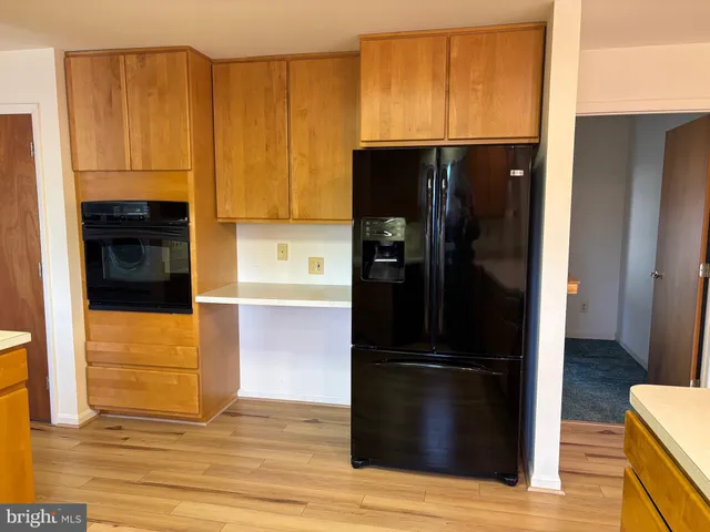 a kitchen with a refrigerator and a stove