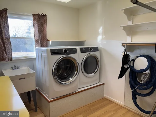 a utility room with sink dryer and washer