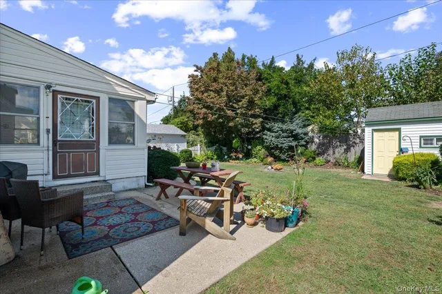 a view of a patio with table and chairs and potted plants
