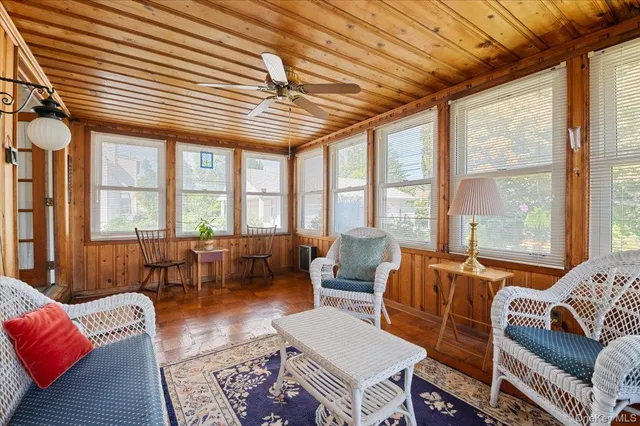 a living room with furniture and large windows
