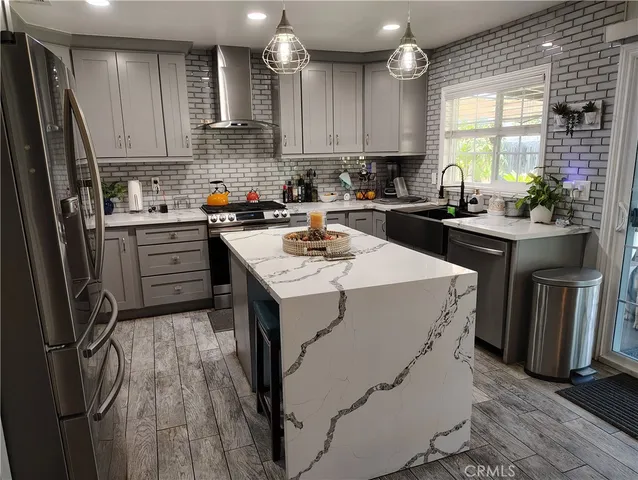 a kitchen with a sink stove and refrigerator