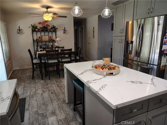 a dining table with chairs and kitchen view