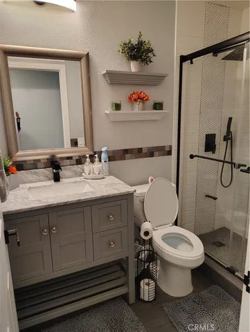 a bathroom with a toilet a sink and a mirror