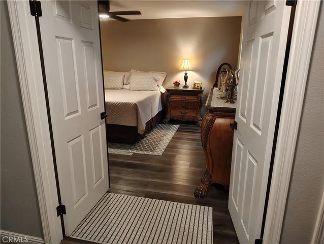 a bedroom with a bed and a mirror