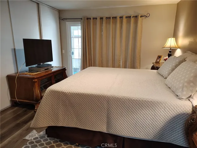 a bedroom with a bed and television