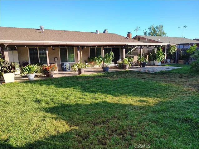 a front view of a house with swimming pool garden and patio