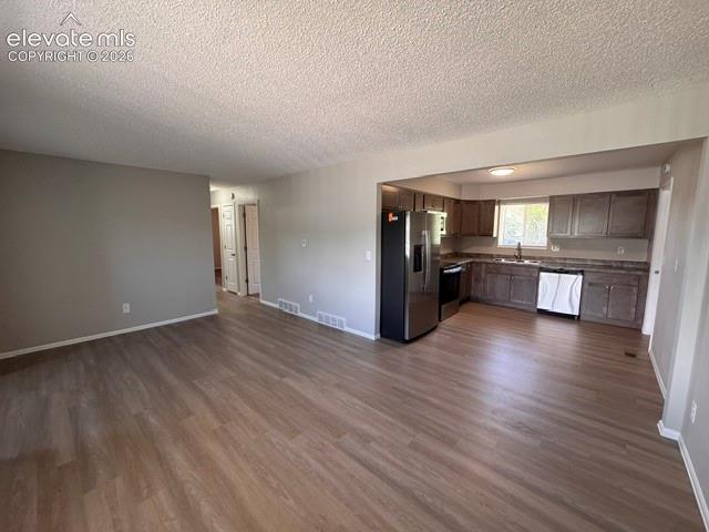 1922 Monterey Road Colorado Springs, CO 80910 - Photo 6 of 21 a view of a kitchen with a sink and a refrigerator