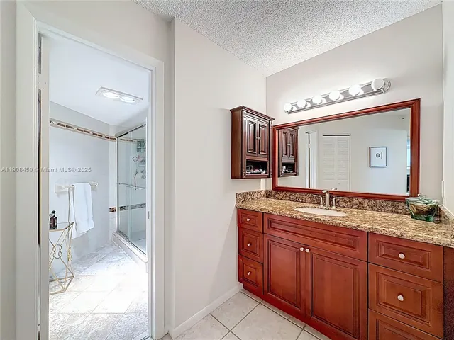 a bathroom that has a glass shower door