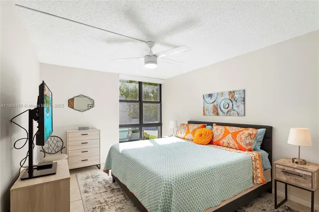 a bedroom with bed and wooden floor