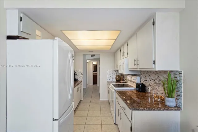 a kitchen with stainless steel appliances kitchen island a table and chairs in it