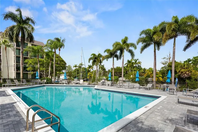 a view of a building with a swimming pool and sitting area