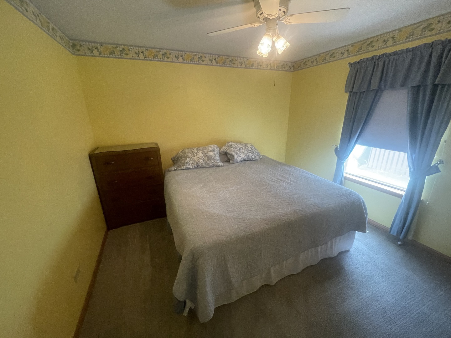 1827 Arbor Falls Drive Plainfield, IL 60586 - Photo 24 of 29 a bed sitting in a bedroom next to a window and a chandelier