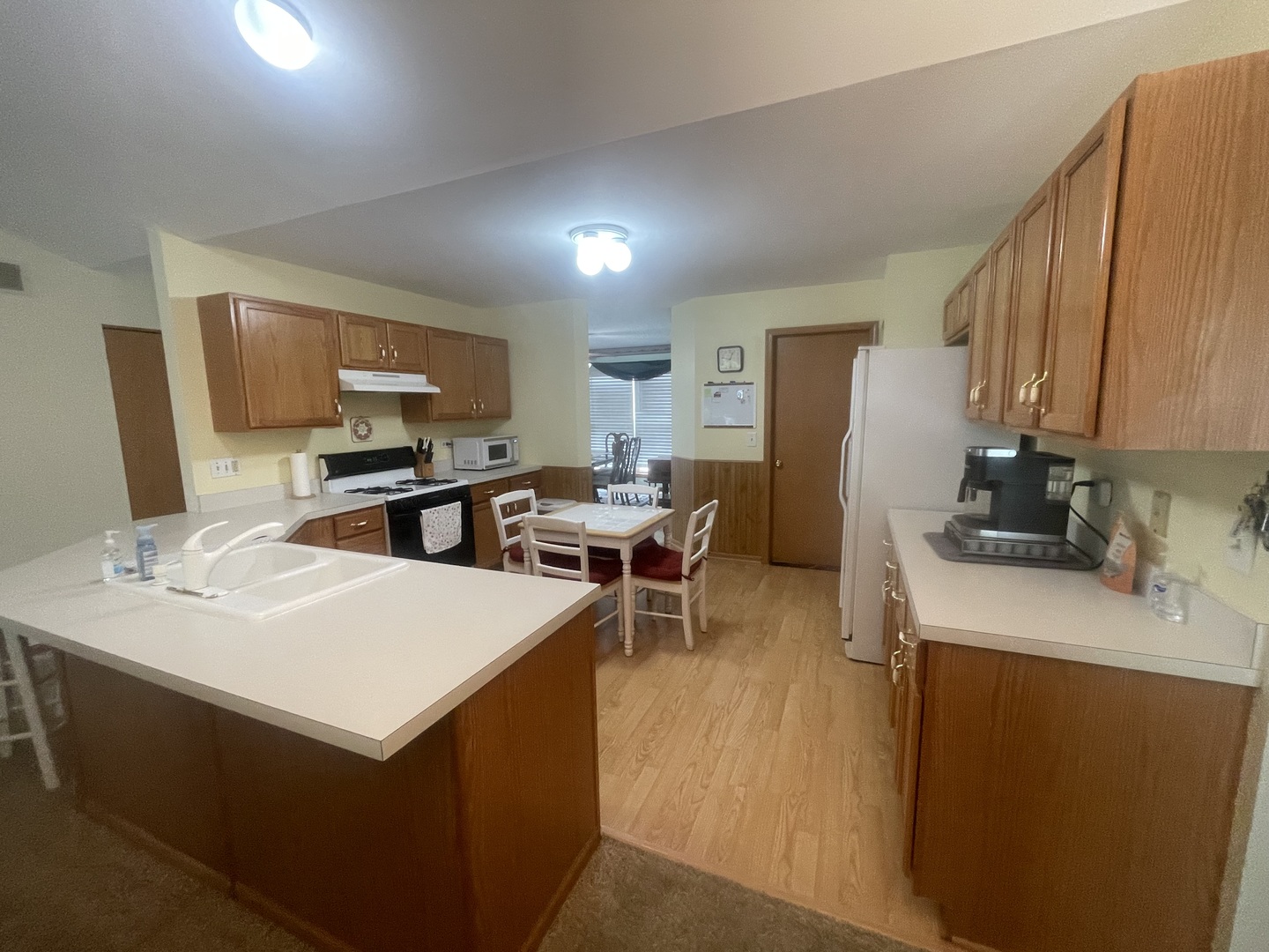 1827 Arbor Falls Drive Plainfield, IL 60586 - Photo 7 of 29 a kitchen with a sink a stove and chairs