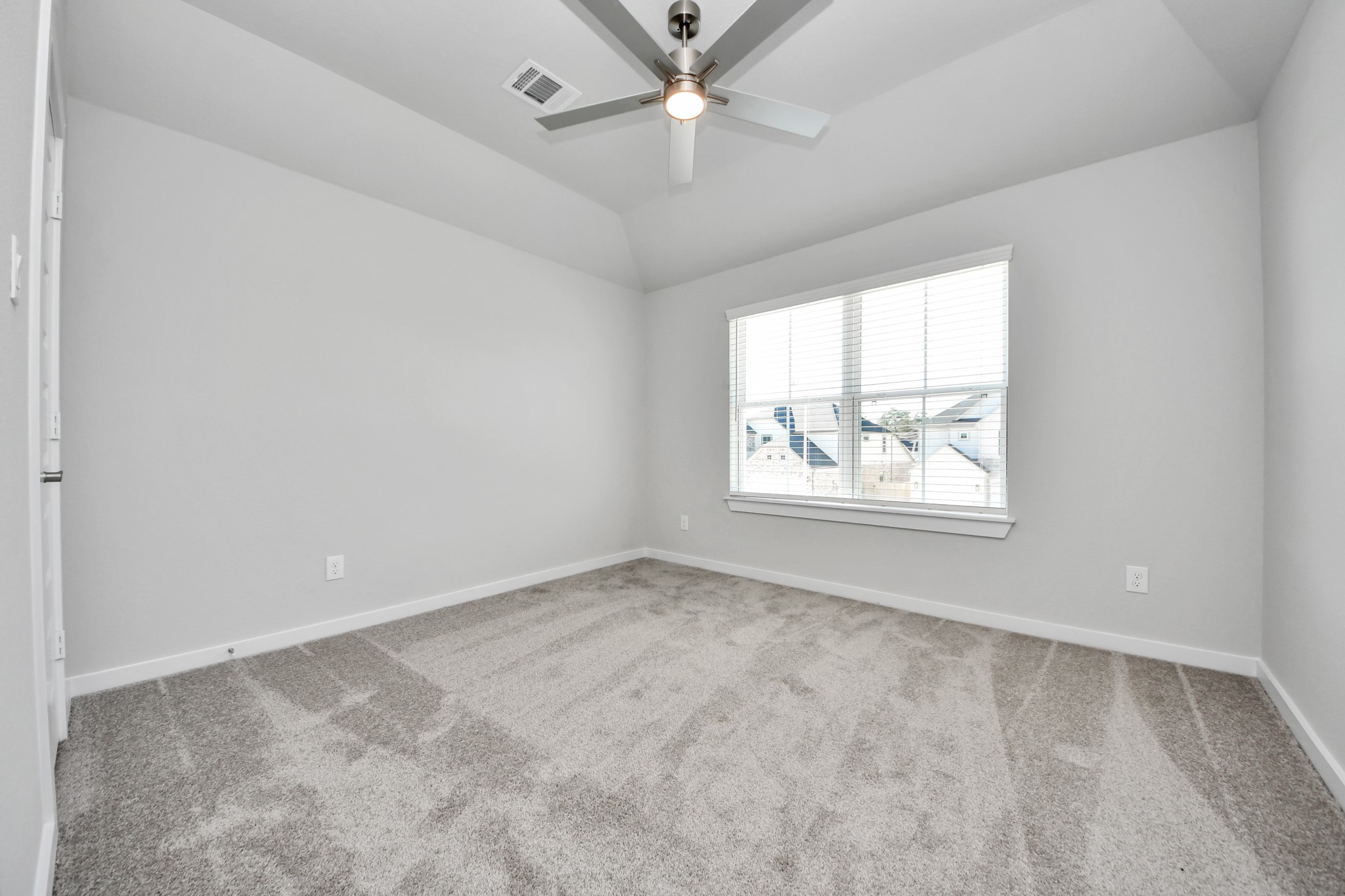 3102 Native Spg Drive Spring, TX 77373 - Photo 35 of 40 Secondary bedroom features plush carpeting, large windows that let in plenty of natural light, bright paint, and spacious closets. Sample photo of completed home with similar floor plan. Actual colors and selections may vary.