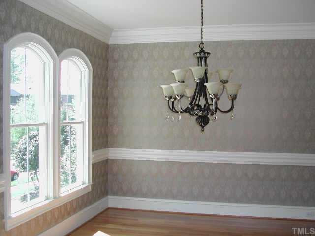 7830 Monument Lane Raleigh, NC 27615 - Photo 5 of 10 Formal Dining Room features Custom Windows, Elegant Chandelier and Wallpaper Other