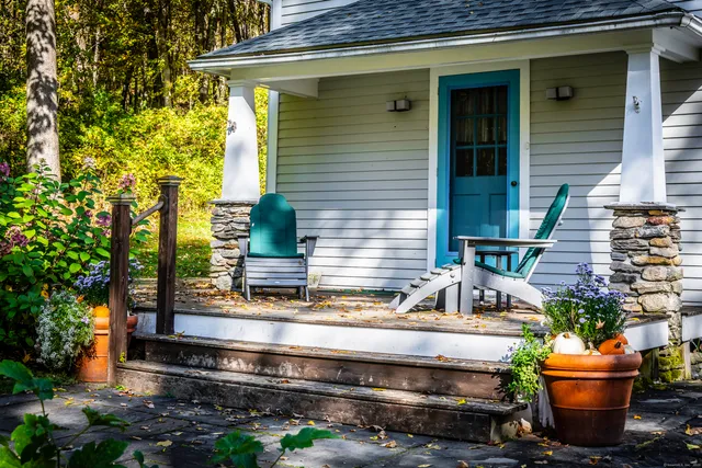 a view of house with outdoor space and sitting area