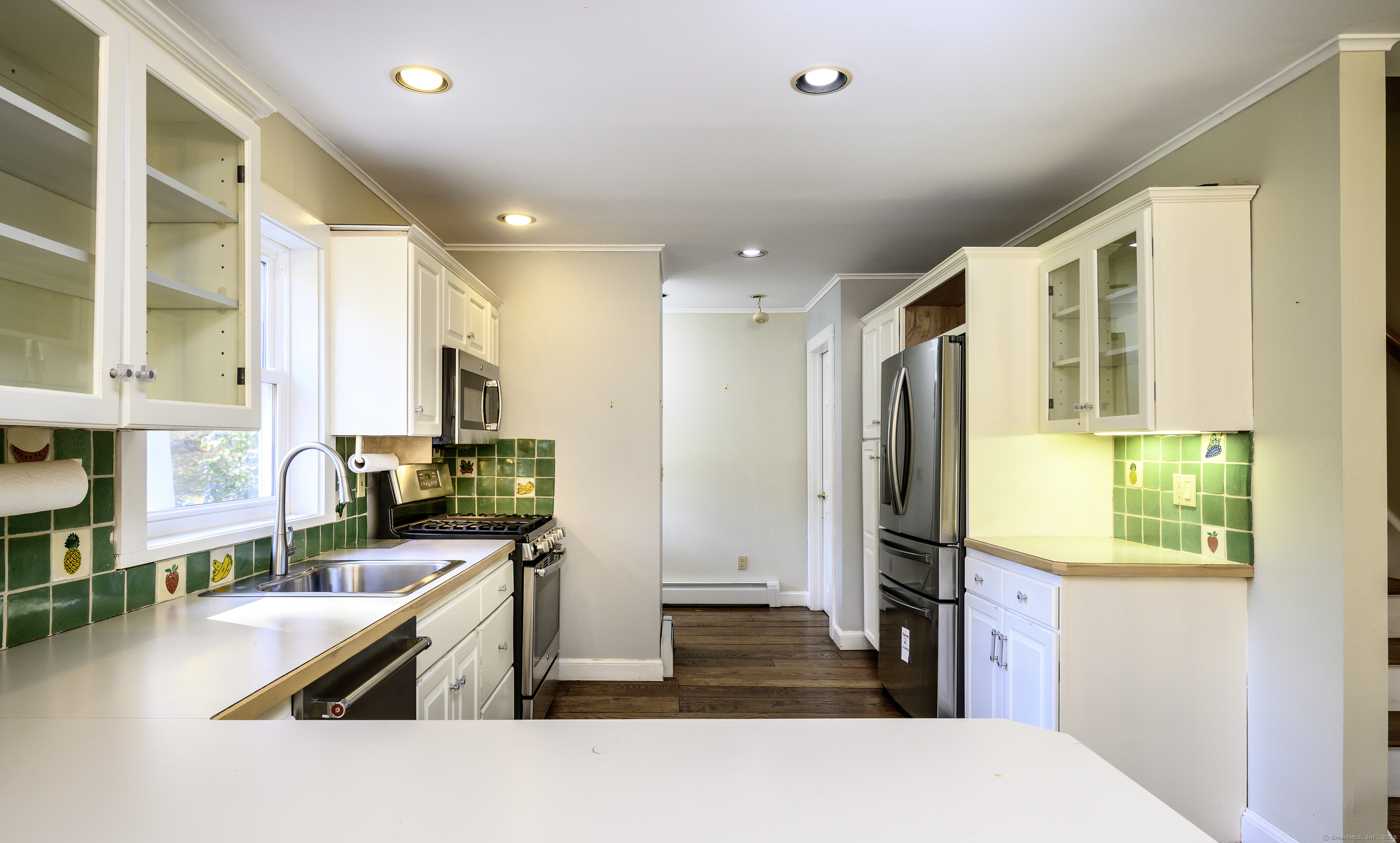 103 Geer Mountain Road South Kent, CT 06785 - Photo 14 of 36 a kitchen with stainless steel appliances granite countertop a refrigerator a stove and a sink with wooden floor