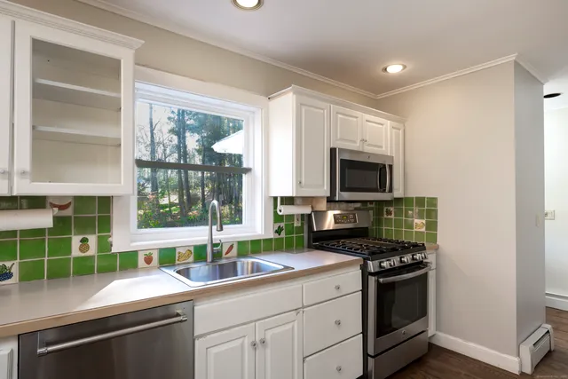 a kitchen with a sink stove and microwave